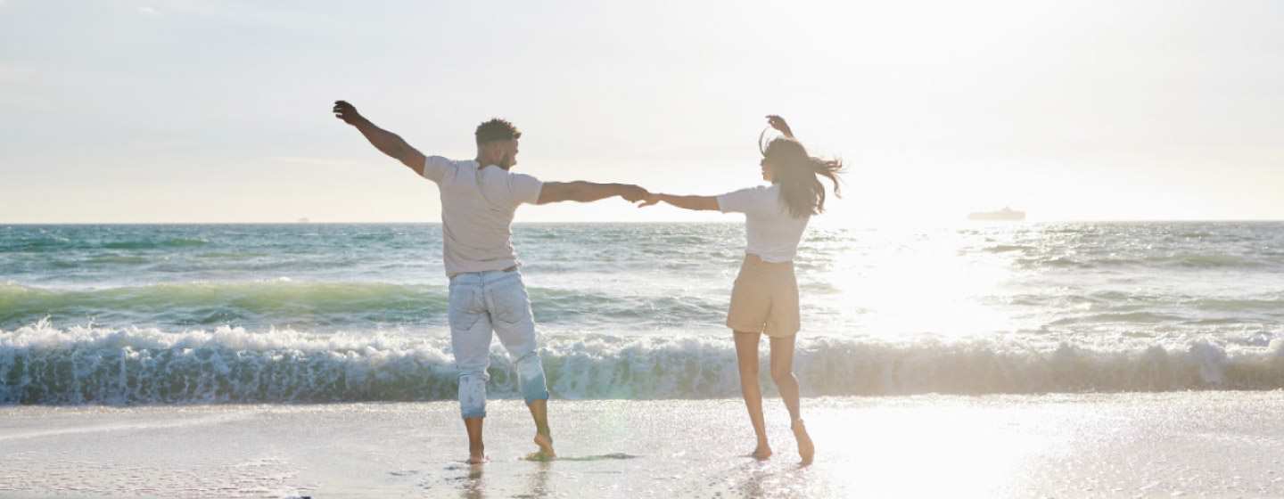 Happy couple dancing on the beach