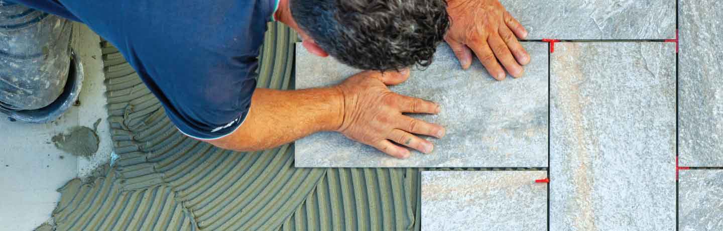 Contractor installing tiles