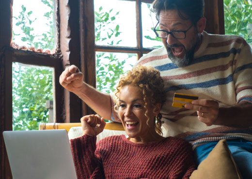 Happy couple looking at a computer